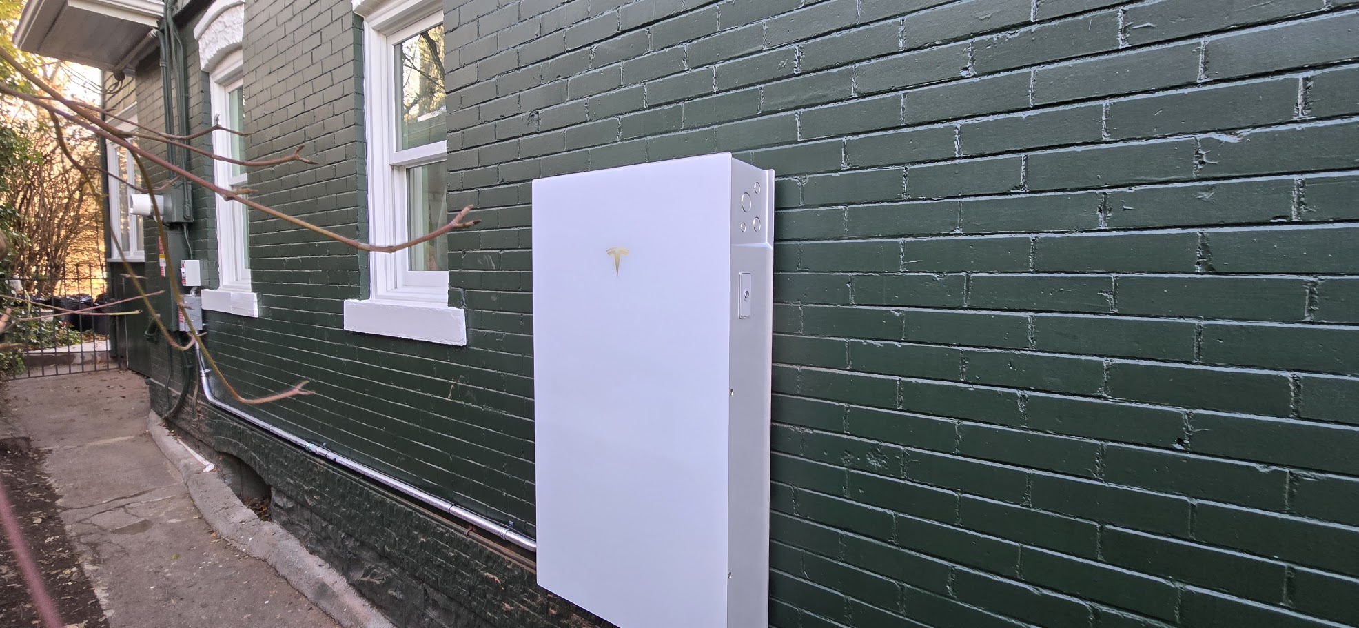 Tesla Powerwall mounted on garage exterior